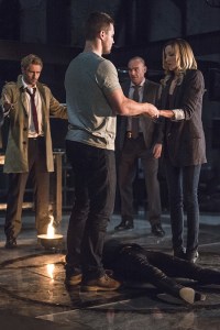 Arrow -- "Haunted" -- Image AR404B_0060b.jpg -- Pictured (L-R): Matt Ryan as Constantine, Stephen Amell as Oliver Queen, Paul Blackthorne as Detective Quentin Lance and Katie Cassidy as Laurel Lance -- Photo: Cate Cameron/ The CW -- ÃÂ© 2015 The CW Network, LLC. All Rights Reserved.